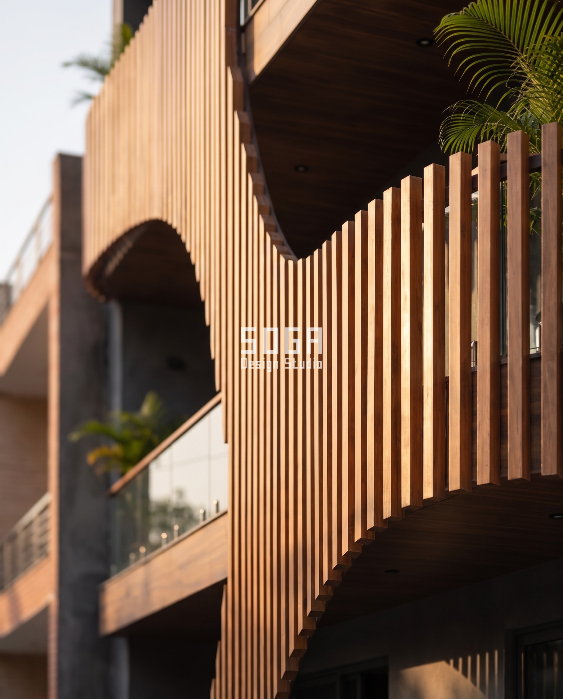 Close up detail of wooden louver fin and curved balcony soffit junction - SOGA Design Studio