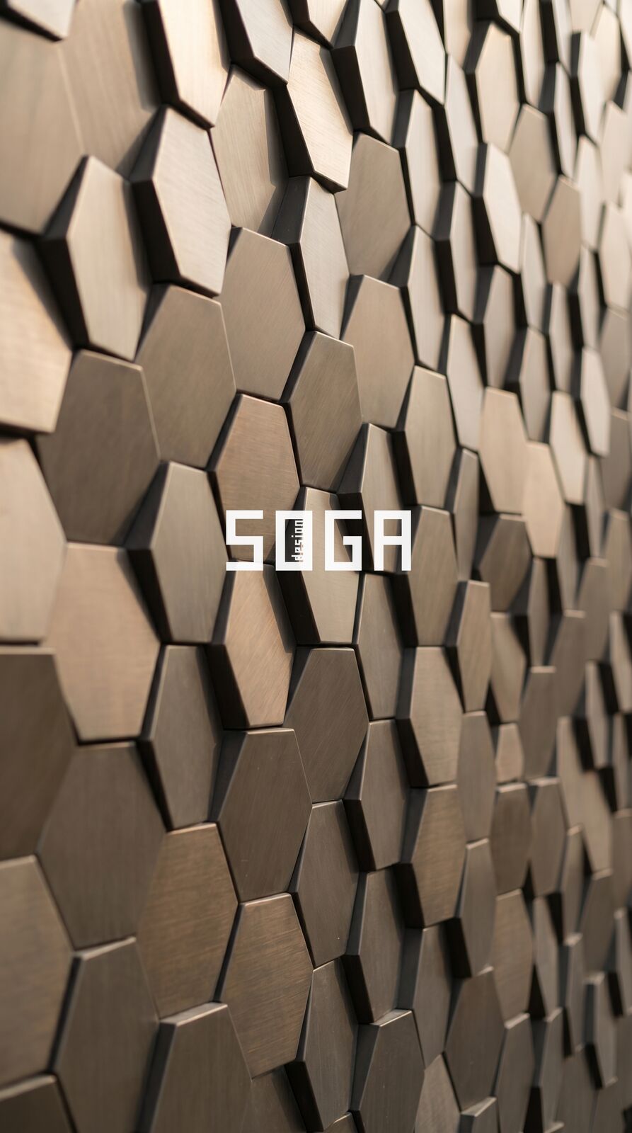 Close-up of hexagonal 3D block facade panels showing fold lines and the projecting faceted faces
