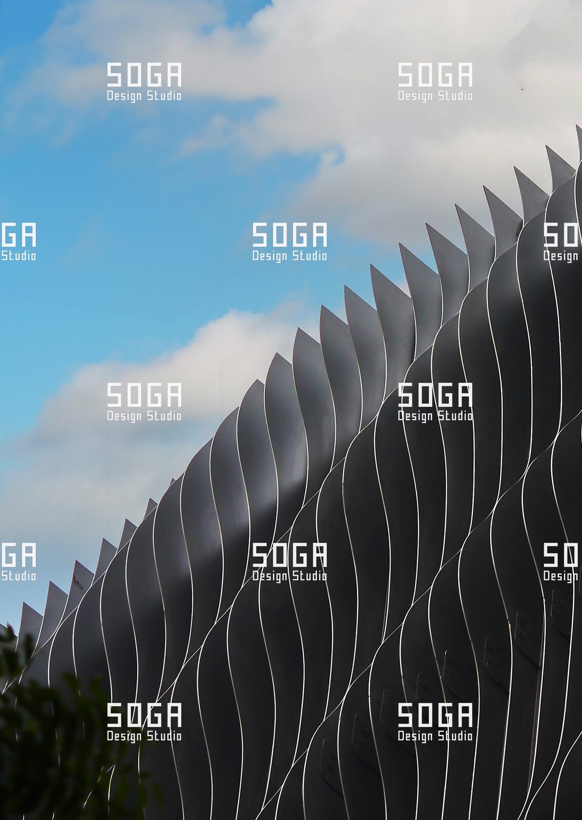 Designed in India, Engineered in India: How Parametric Facade Systems Became Manufacturable for Indian Projects 7 Slicing fin facade of progressively varying vertical metal fins reading as a curved surface against the sky