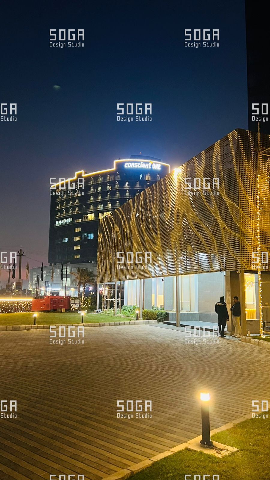 SOGA Coin Facade Installation: Sequencing, Tolerance and Site Realities in India 8 Coin facade lit at night after handover, showing alignment across the completed elevation