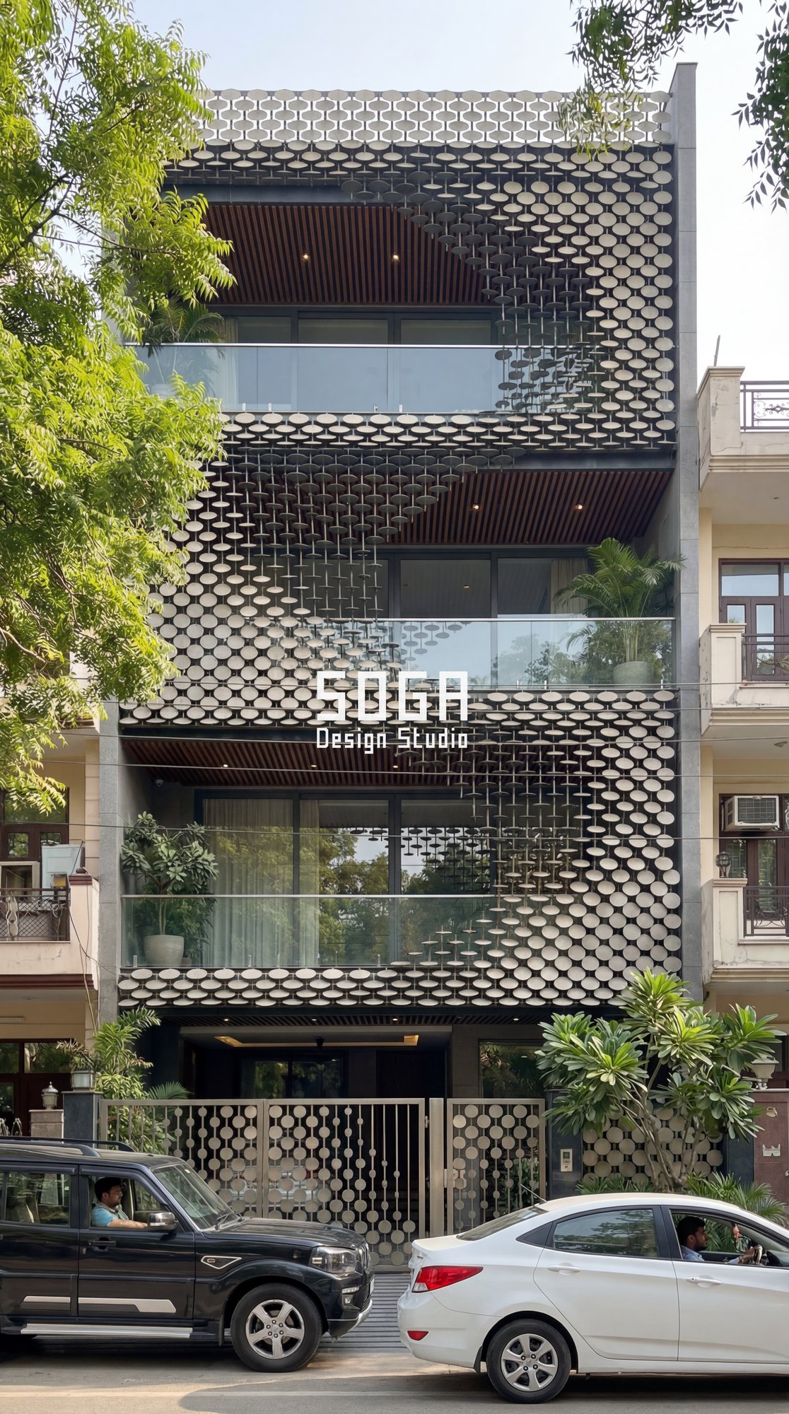 Scalloped metal shingle skin covering the full front elevation of a narrow urban house in India — SOGA Design Studio