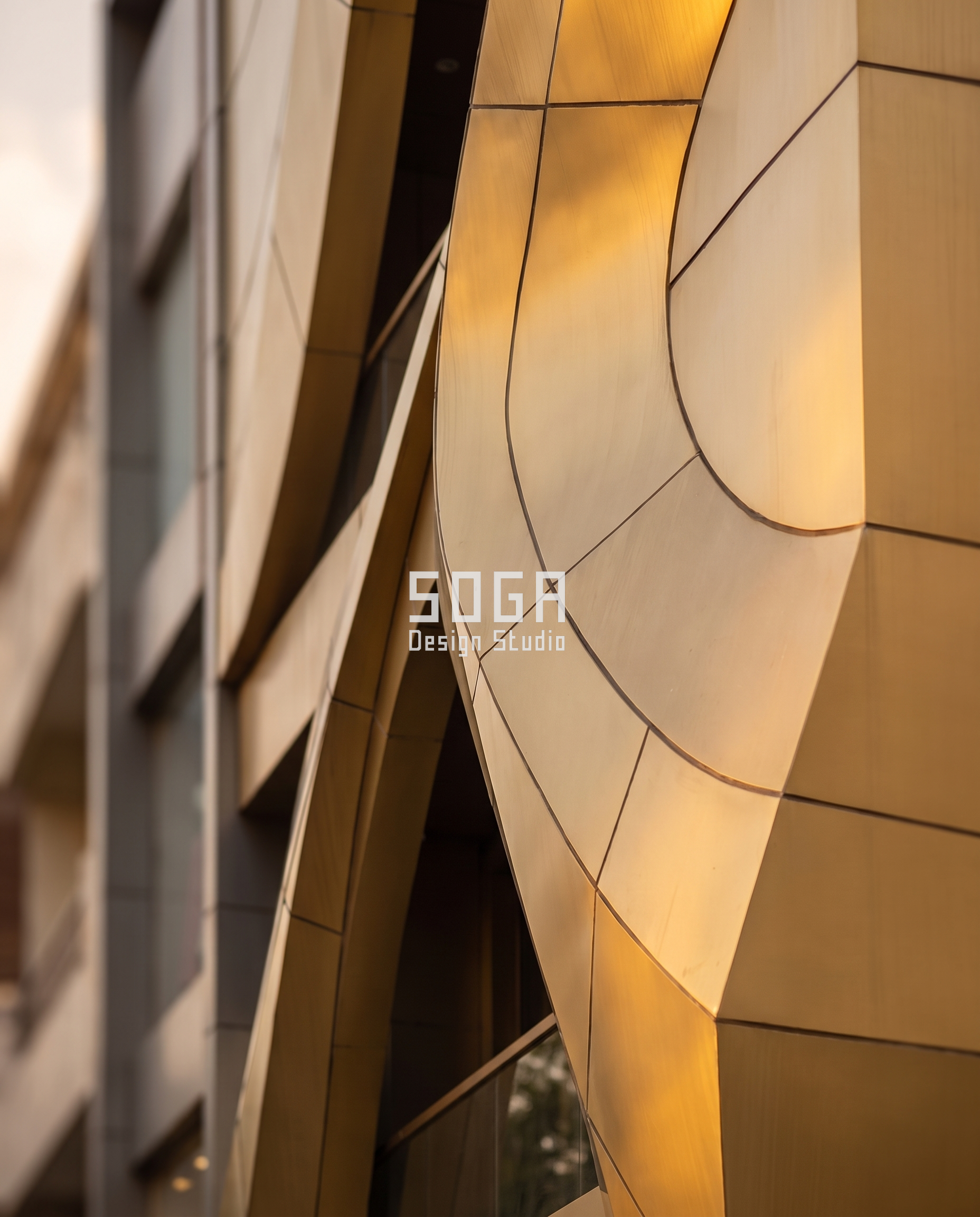 Nawaabi Gold: A Jewellery Showroom Facade Folded and Curved Like Hand-Worked Gold 7 Detail view of the arched portal entrance of Nawaabi Gold, folded metal sheet meeting the storefront glazing - SOGA Design Studio