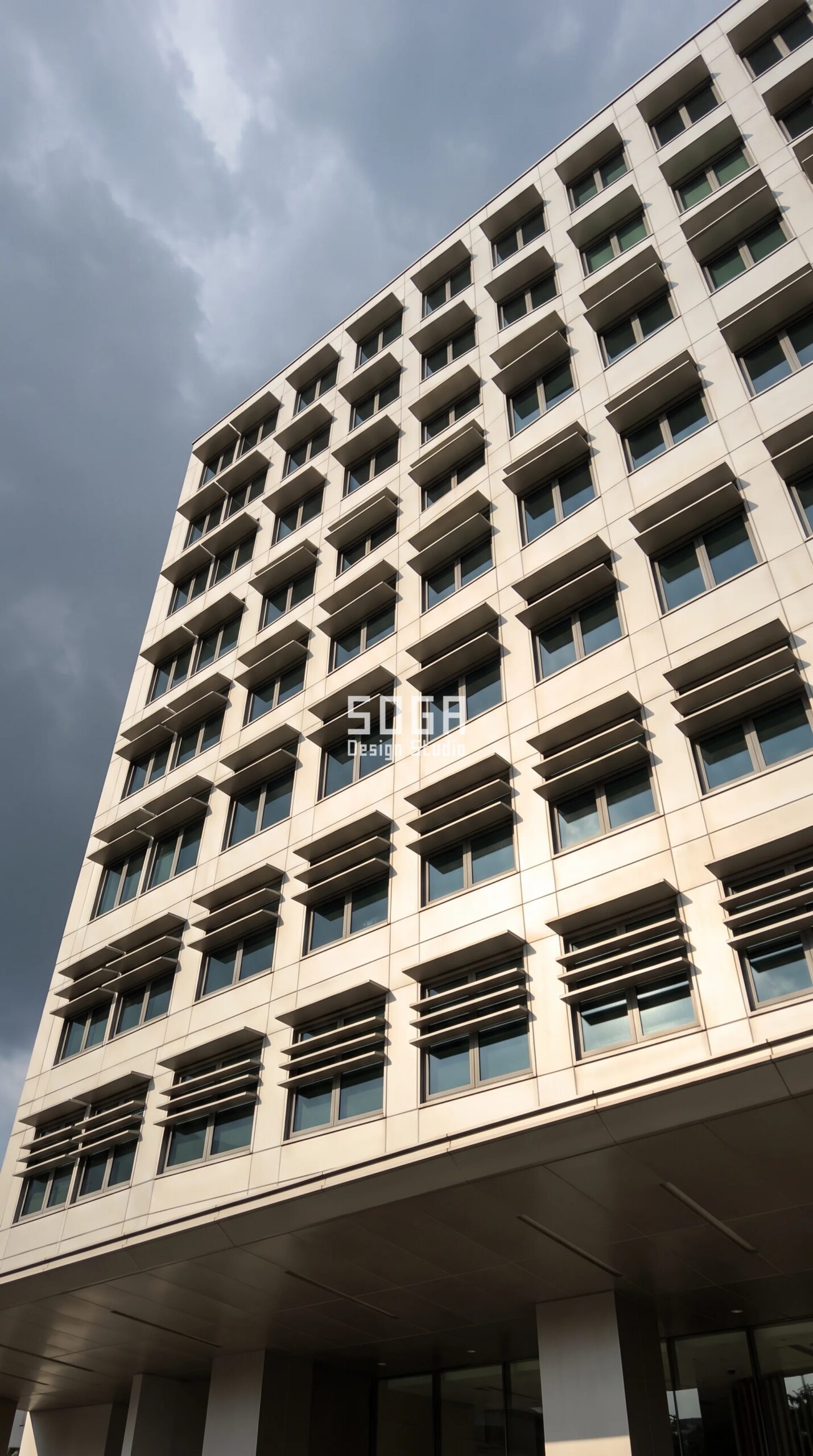 Commercial Facade Mockup Testing Cost: 4 Markets 2026 3 Parametric Brow Transom Grid pewter stainless steel commercial facade on a G+9 Paya Lebar Singapore office building - SOGA Design Studio