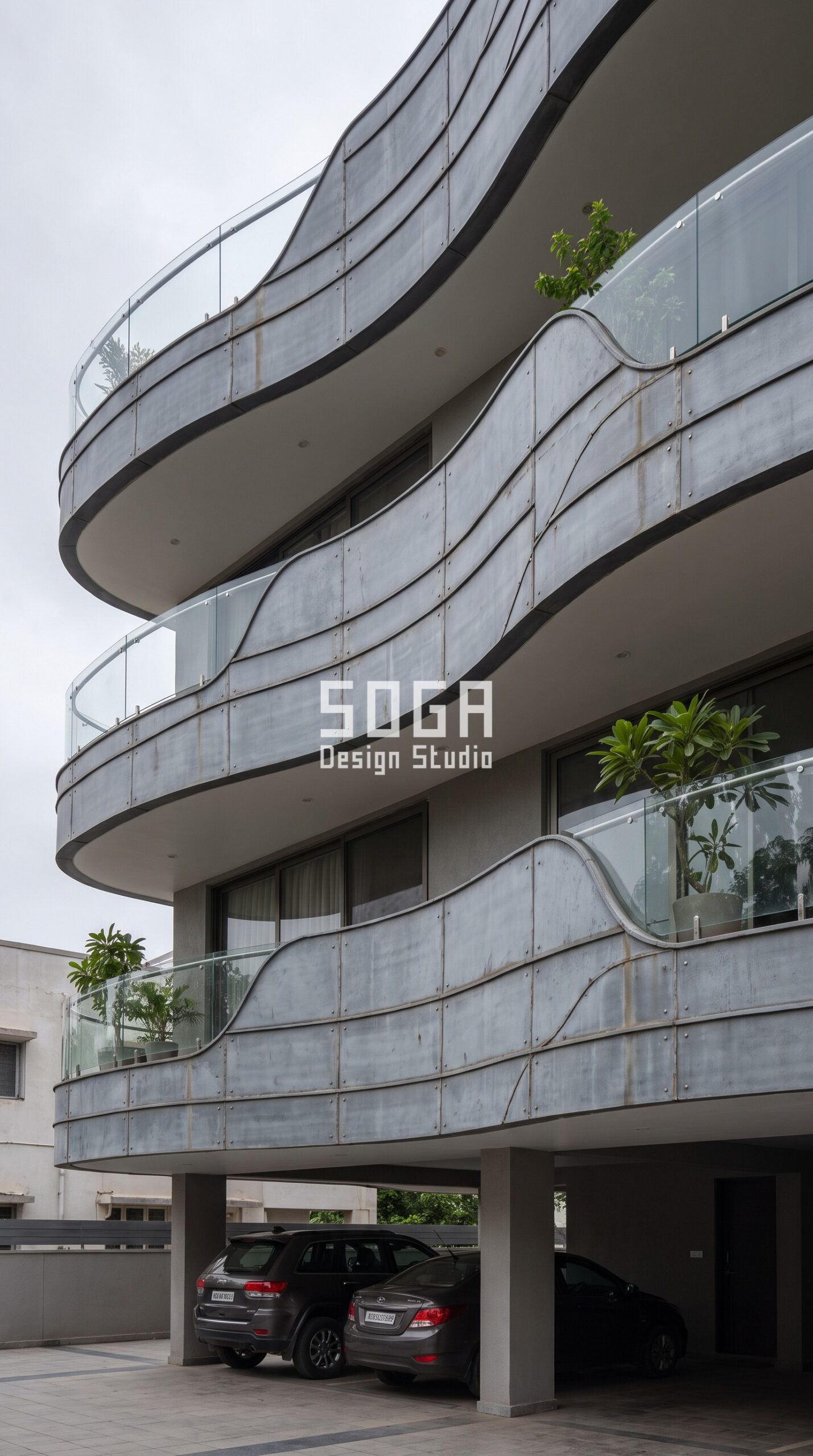 Do Curved Balconies Reduce Usable Area? India 2026 4 Parametric Current Shell aged pewter grey zinc alloy facade, Alkapuri, Vadodara - SOGA Design Studio