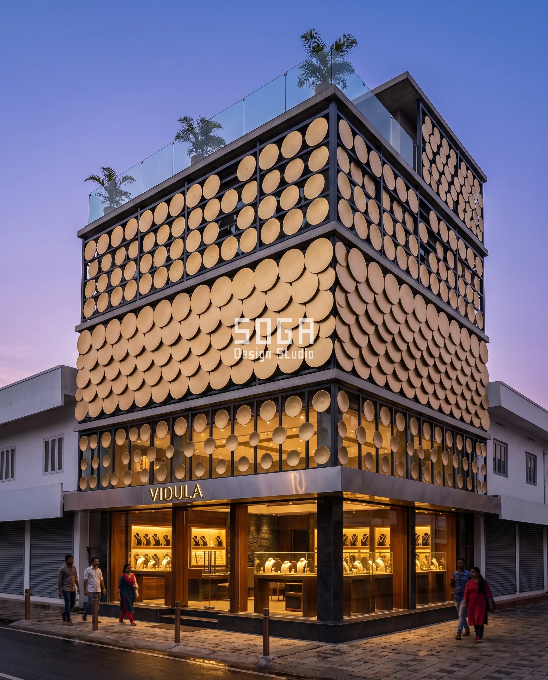 Graduated Perforation Jewellery Showroom Facade India 2 Corner view of a Kozhikode jeweller after sunset showing how the screen is built: champagne-gold discs bolted as fixed overlapping scales onto a dark steel lattice, small and airy over the entrance and lapping into a near-solid band across the first-floor bridal gallery