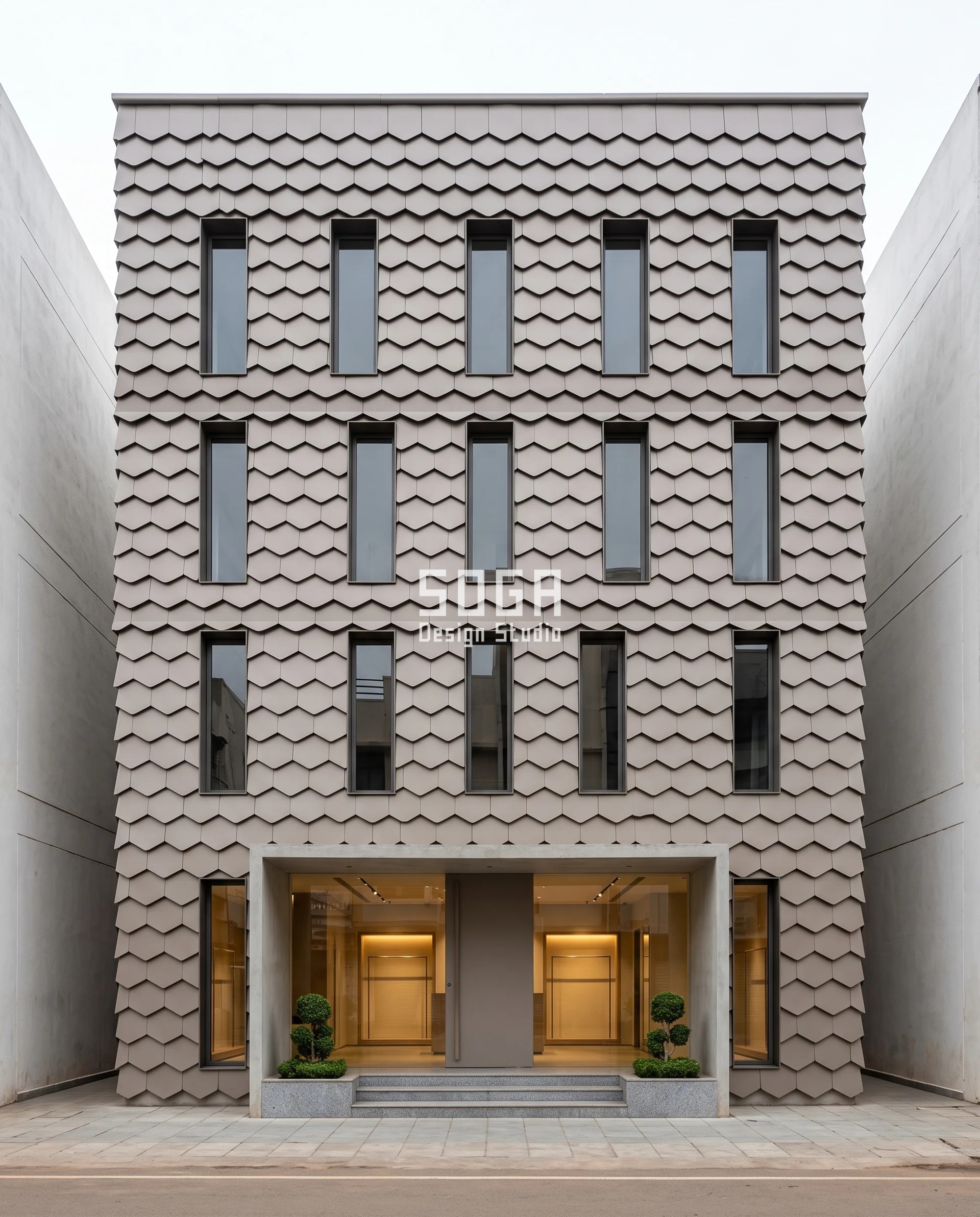 Overlapping stone-taupe hexagonal metal scales climbing the three upper floors of a narrow Hubballi showroom, each lap closing the small shelf that a pigeon proof balcony without net has to design out.