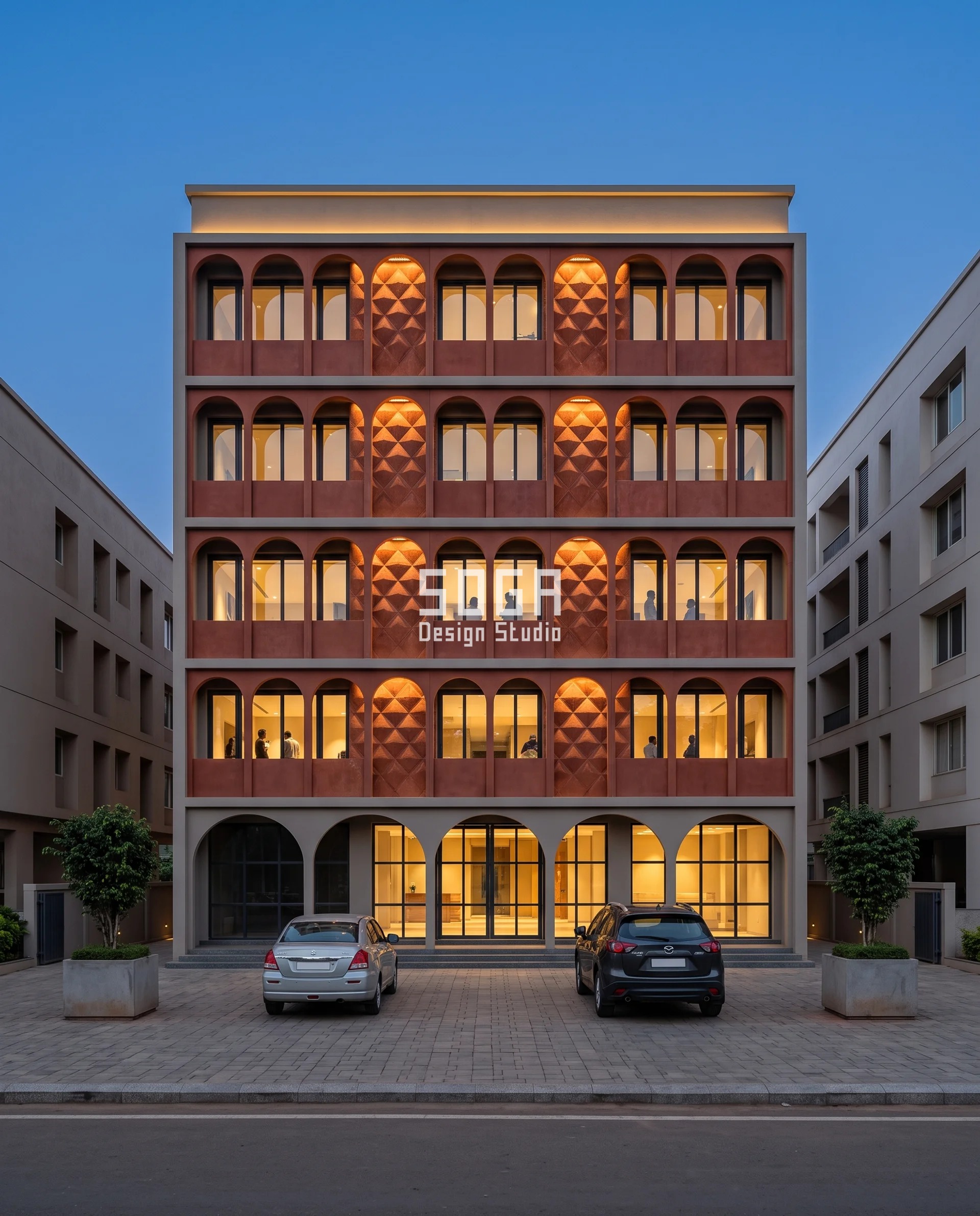 Stop Rain Water Entering Balcony India With 692 mm Reach 3 Russet-red precast concrete diamond emboss lit at dusk behind a slim arched colonnade in Bhubaneswar, courses offset 0-500 mm so no valley stacks vertically and rain never sheets onto the entrance below.