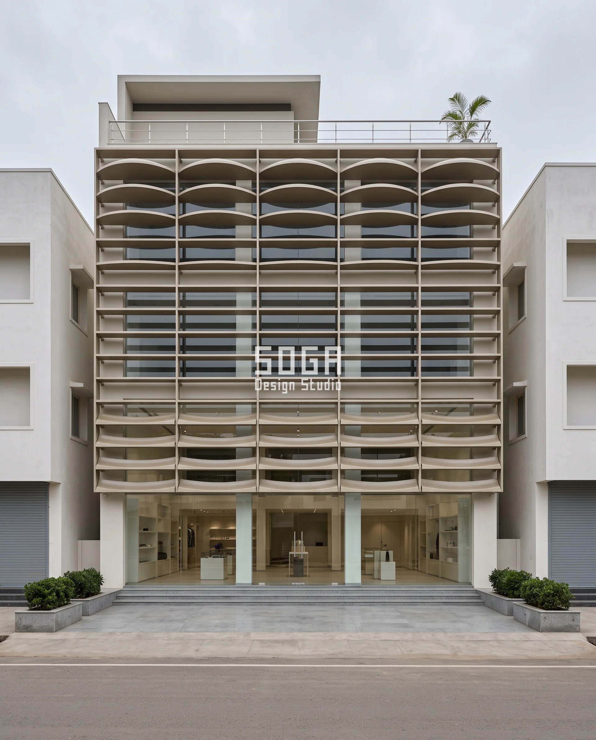 Facade Screen Without Making the Room Dark: India Numbers 5 Almond-beige aluminium shelf array on a Davanagere showroom, the shelf profile reversing from deeply scooped troughs at the display floor to domed ridges at the top - a facade screen without making the room dark in India.