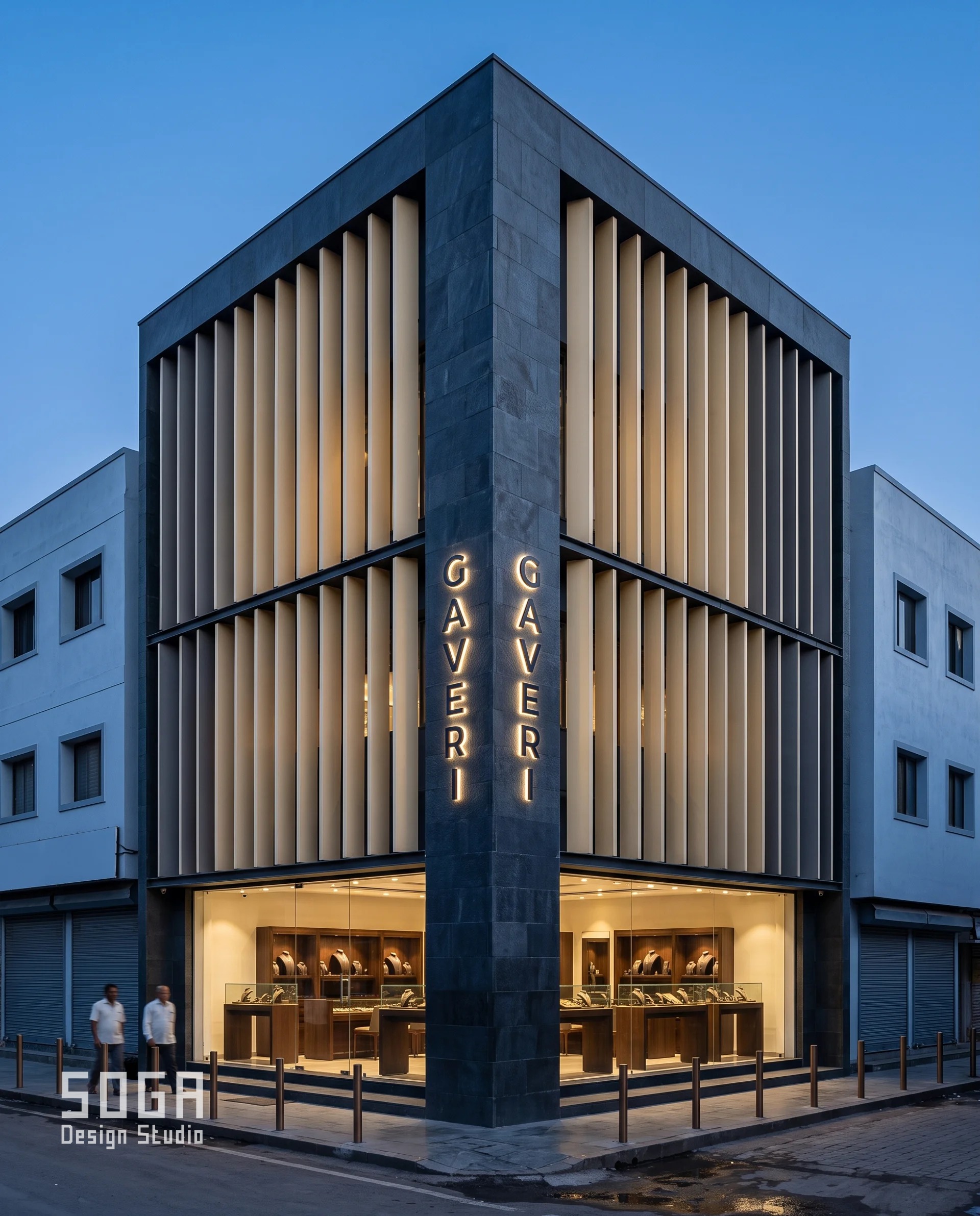 Corner plot jewellery shop facade design in Nashik where a solid basalt pier holds the building line and the raked terracotta fin screen stops against it and steps back on each street