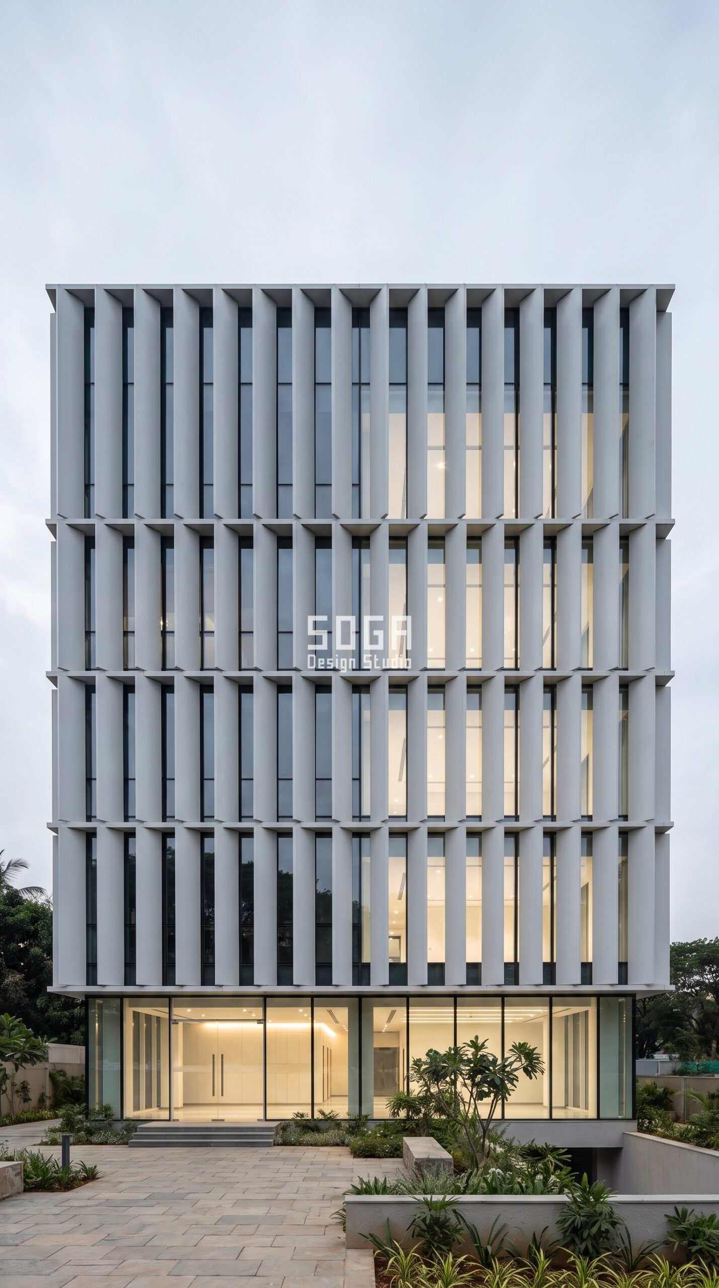 Why Facade Design Matters for Commercial Buildings 2026 3 Commercial office facade with rotating pale grey vanes controlling daylight and glare, Bengaluru India - SOGA Design Studio