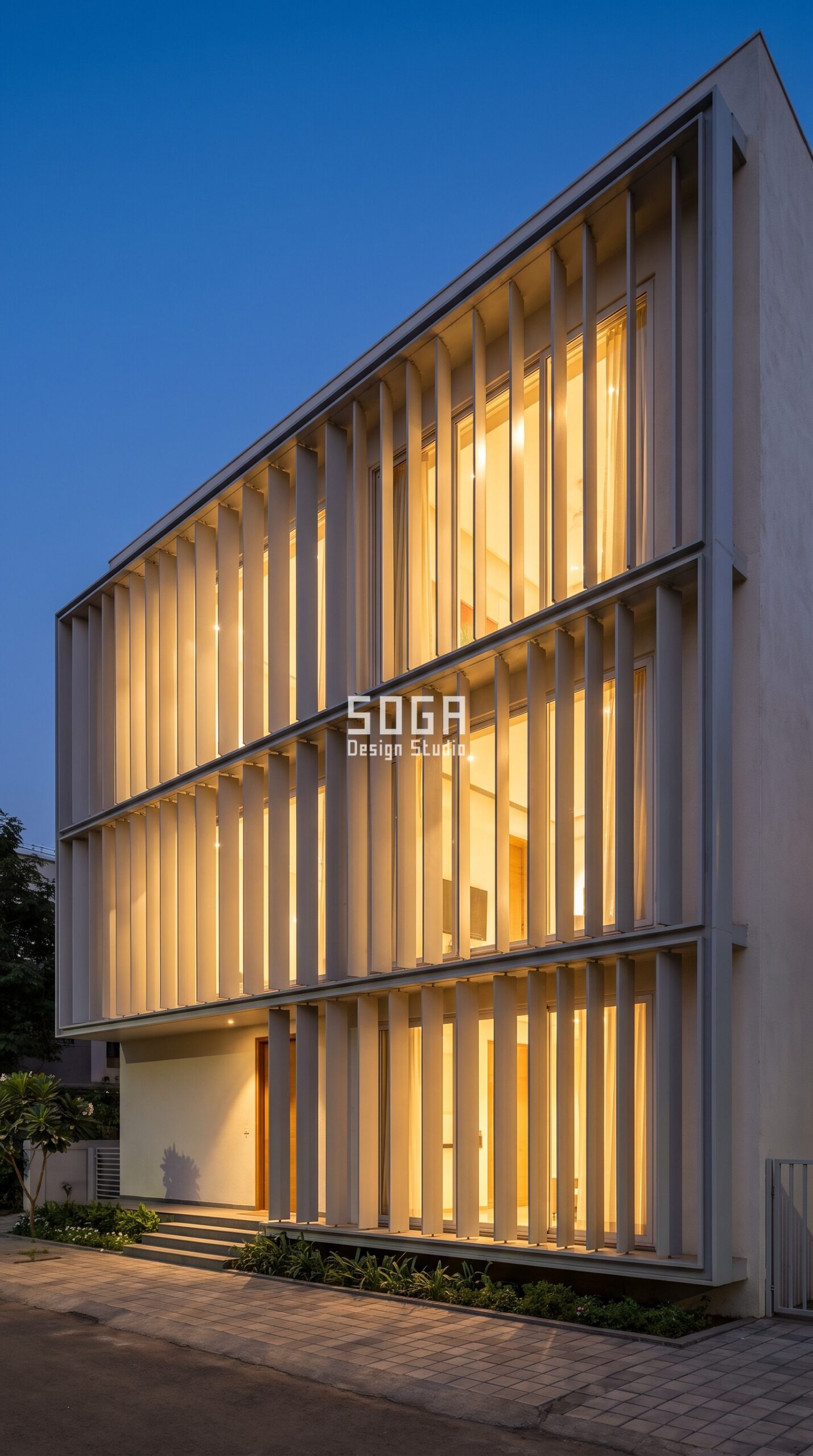 Why Elevation Design Matters: 7 Factors for Indian Homes 3 House elevation with pale fins filtering warm interior light at dusk, Pune India - SOGA Design Studio