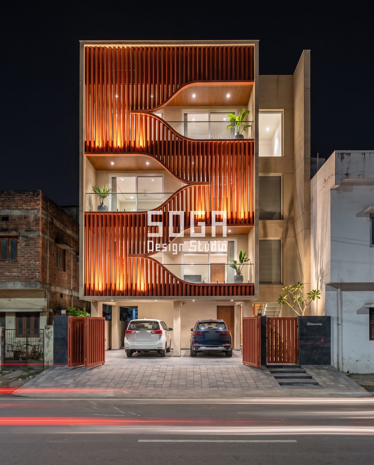 Slat and Fin Facade Ideas India: 4 Concepts for Shops and Homes 4 Night view of a four-storey India building with an orange-lit vertical fin veil cut by pointed notches at three levels