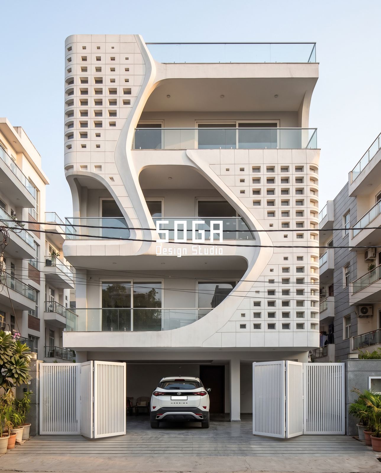 Organic Facade Design: Why It Doesn't Mean Curves 4 Organic facade design combining a continuous curved sweep with a rigid perforated block screen, residential India