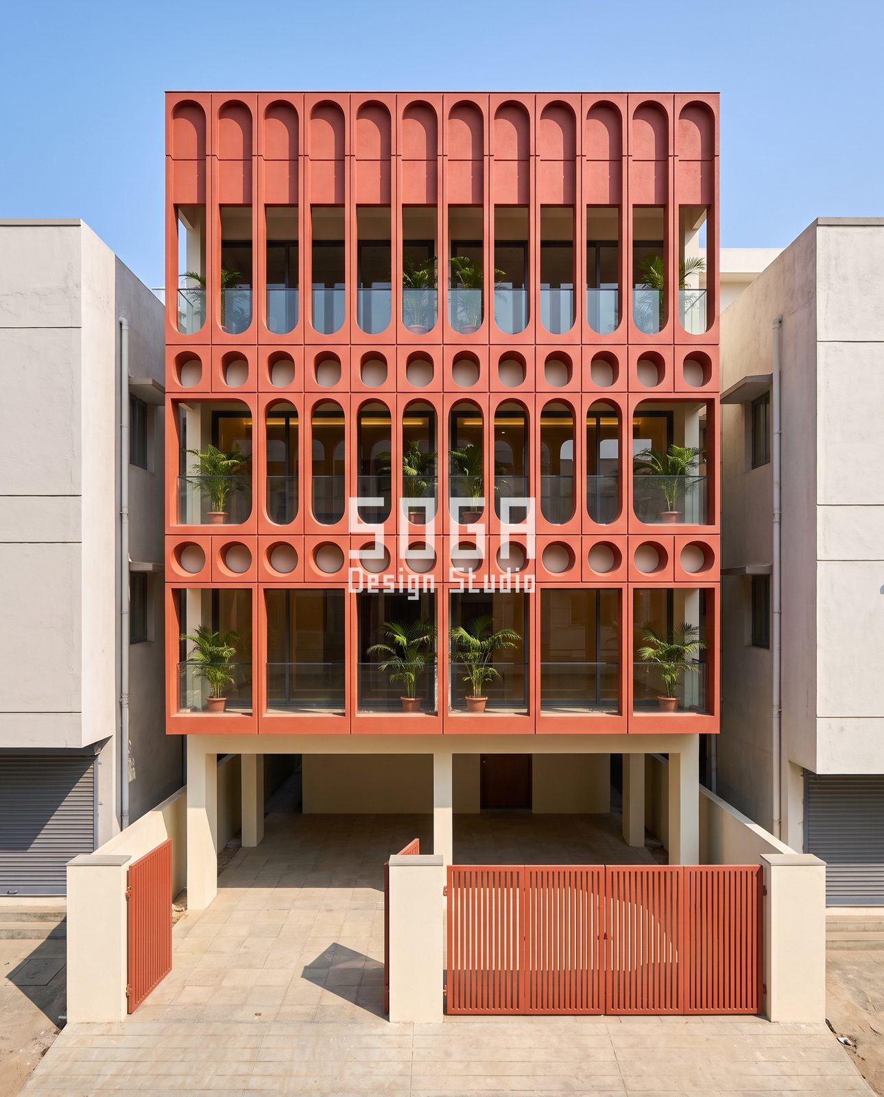 Spine, Capsule, Lancet, Ribbon and Frame: 5 Cantilever Balcony Facade Ideas for India 2 Red terracotta-tone capsule and roundel grid facade over stilt parking with balconies, India
