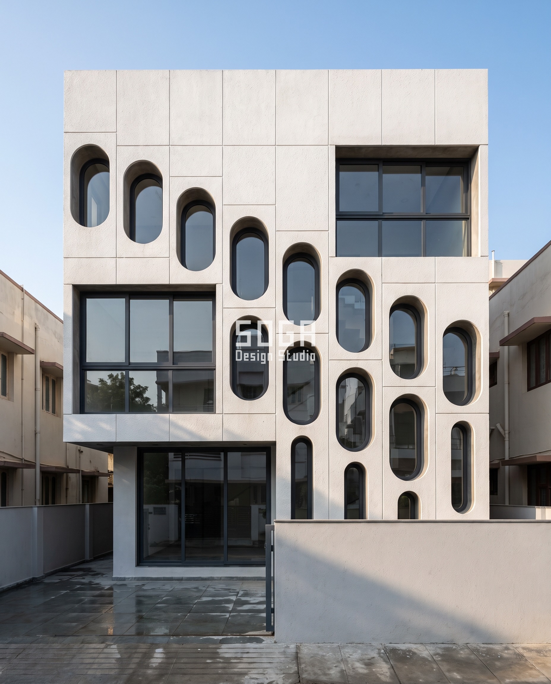 Parametric Transmittance Slot villa facade in Kotturpuram Chennai - bone-white GFRC screen with obround apertures stretching 450 to 900 mm across the west face