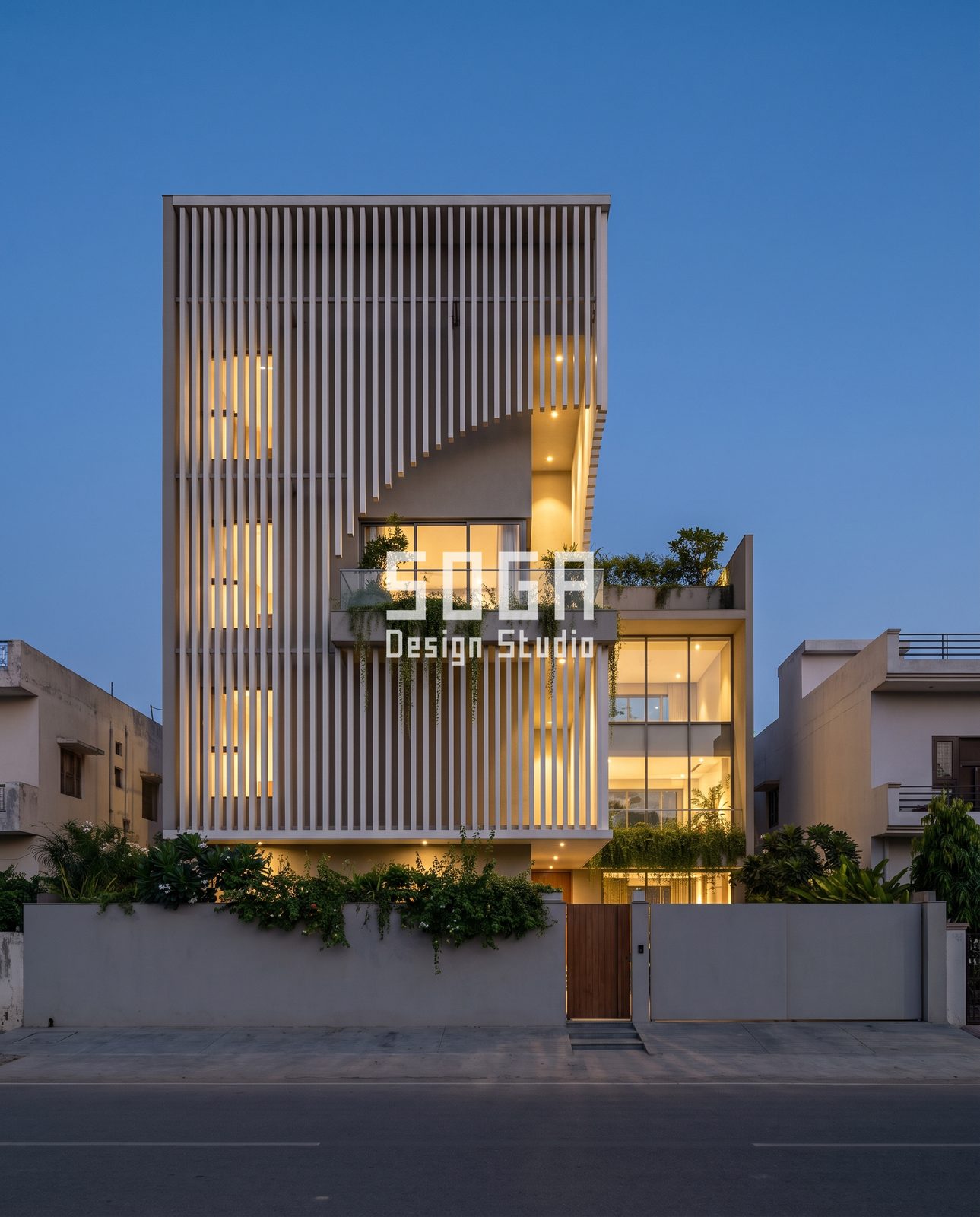 Twisted, Looped, Leaning, Waved and Slatted: 5 Sculptural Balcony Facade Ideas for Indian Homes 5 Off-white vertical slat tower with a diagonal cut and warm glowing windows at blue hour, India