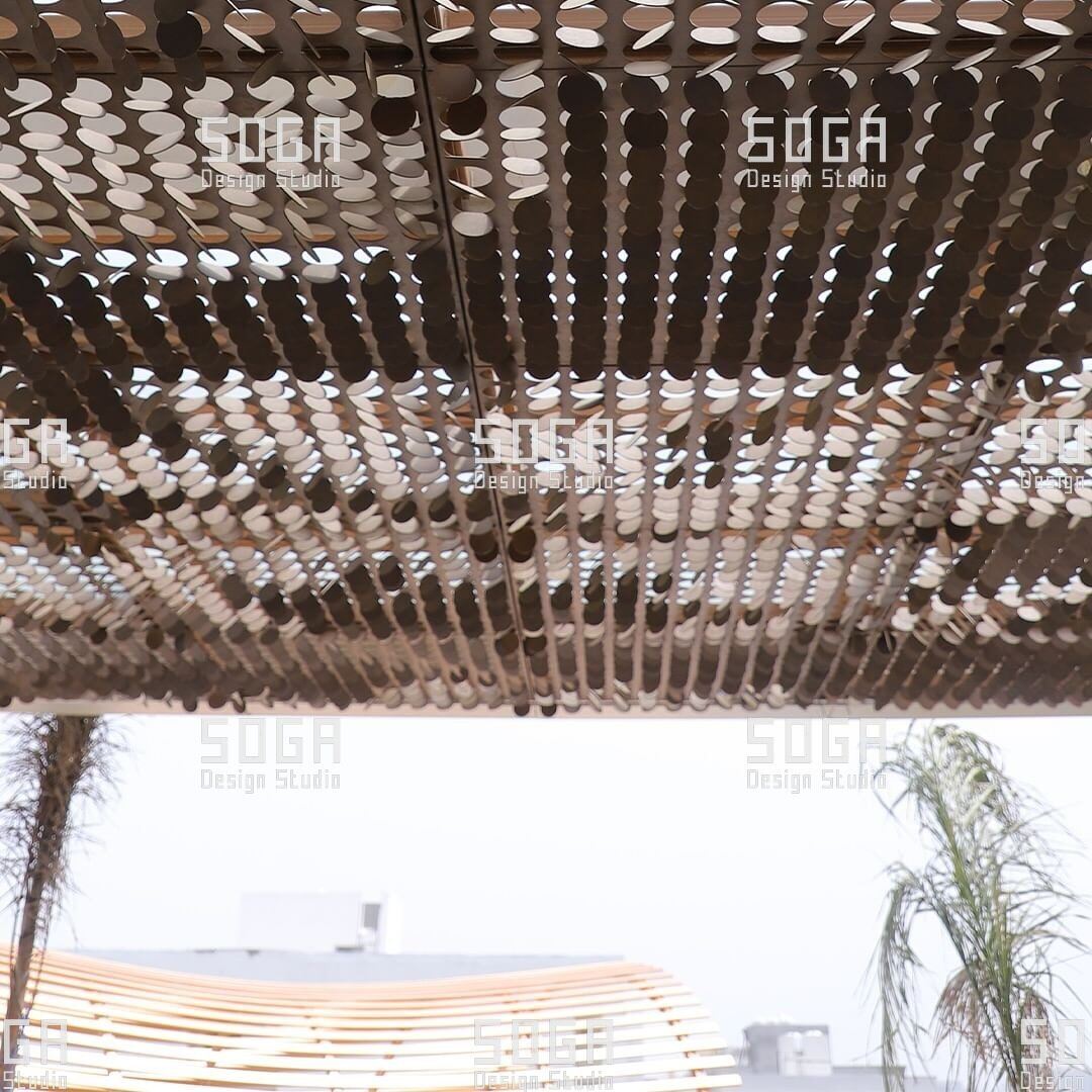 MetaCoin Facade System: How Rectangular Panels With Circular Coin Mechanisms Actually Work 6 Coin facade panels seen from below at a soffit, showing the assembled underside of the panel field