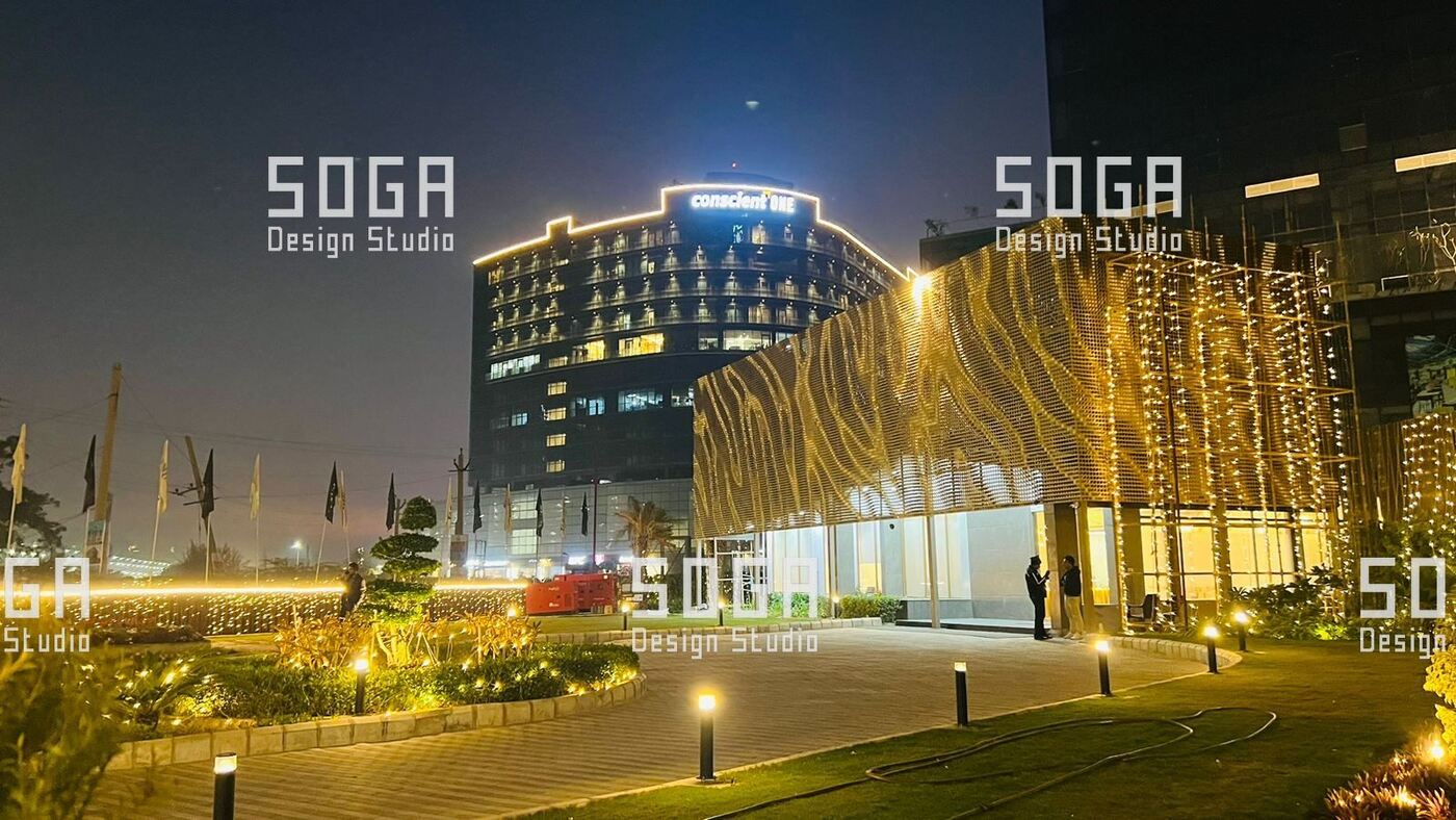 Parametric Coin Facade, Gurgaon: The Design Story Behind 216 Panels and a Field of Angled Coins 8 Night view of the coin facade building seen from the approach road in a commercial district