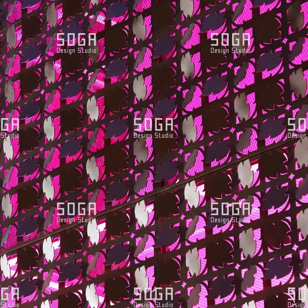 Coin Facade Design: The Parameters That Decide How a Coin Facade Looks 8 Coin facade field lit at night in a strong colour, the discs picking up light across the surface