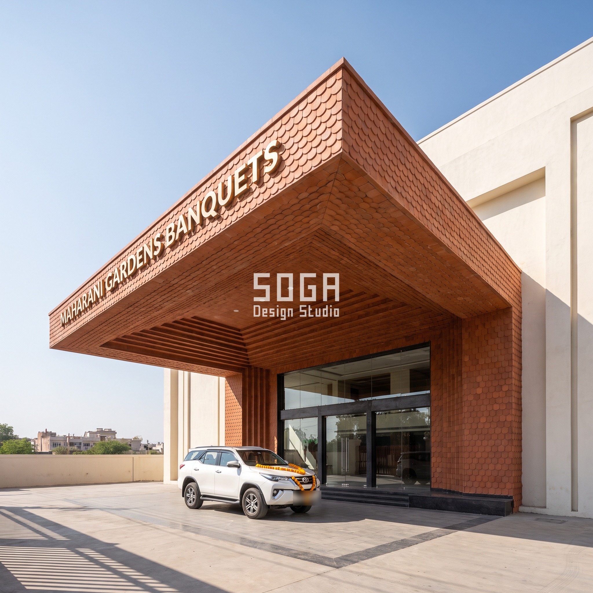 Banquet Hall Facade Design 2026: India, Dubai, Singapore 1 Jaipur banquet hall porte-cochere with a terracotta scale canopy coarsening from the eave to the wall over an 11-metre clear span